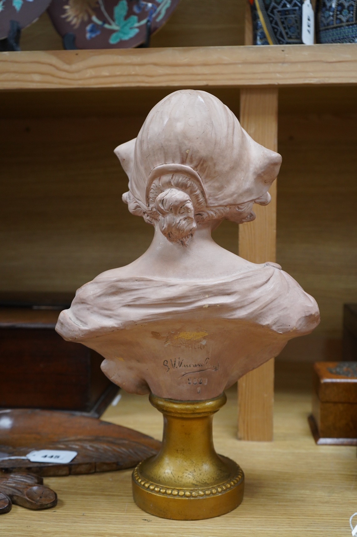 A painted terracotta bust of a maiden, indistinctly signed and numbered 1320, 41cm high